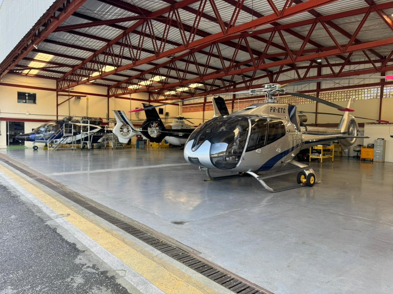 Helibarra hangar interior with helicopter fleet