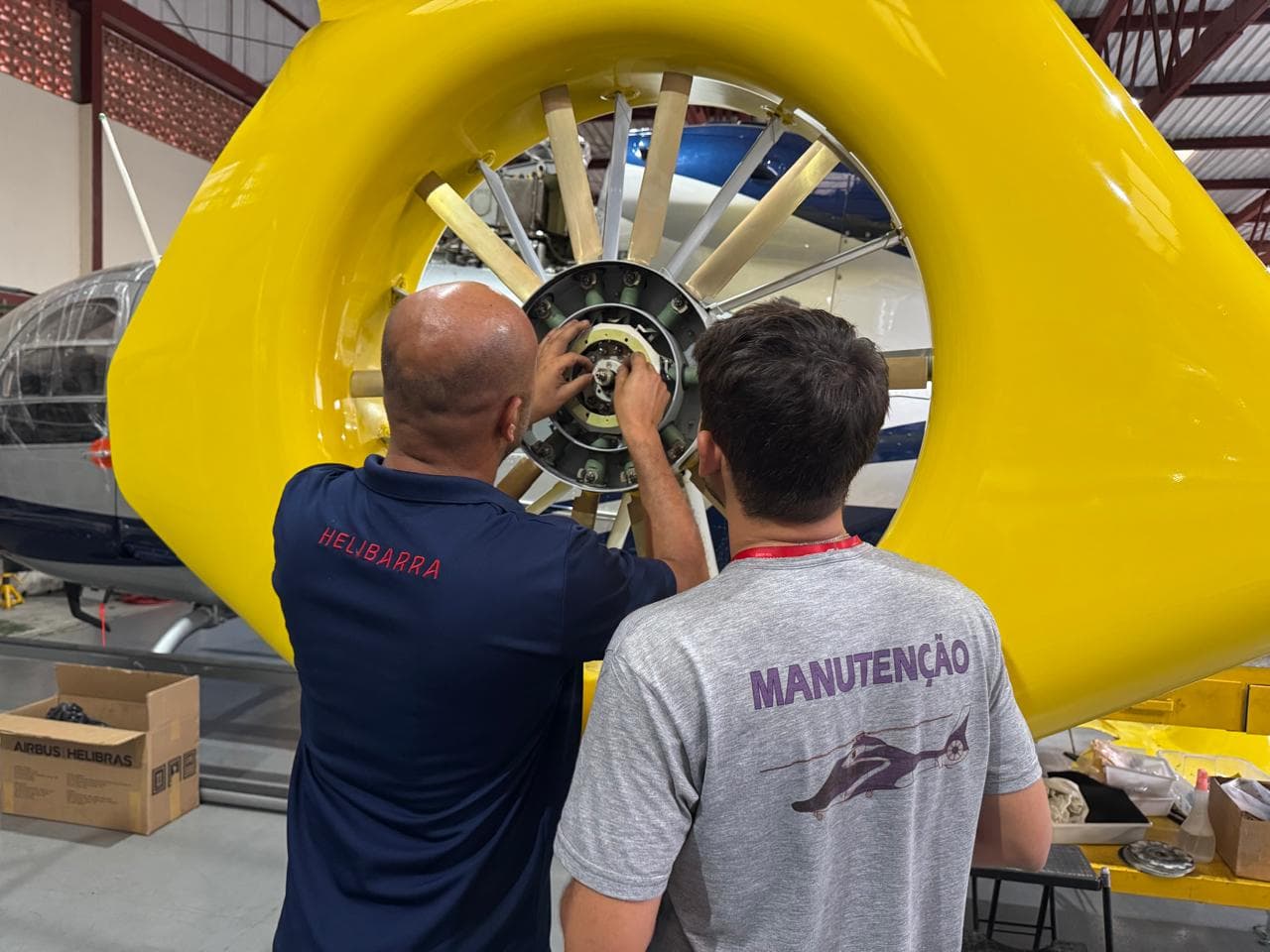Helibarra maintenance technicians servicing a helicopter rotor hub